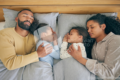 Image of Sleeping, family and relax in bed from above, relax and resting in their home on the weekend. Sleeping, comfort and top view of parents embracing children in a bedroom with love, nap and dreaming