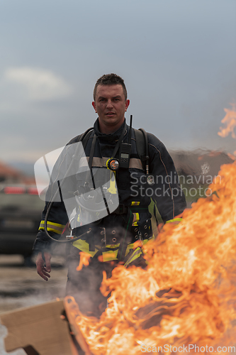 Image of Close-up portrait of a heroic fireman in a protective suit. Firefighter in fire fighting operation.