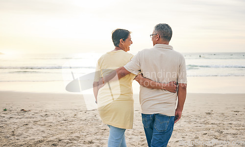 Image of Beach, hug and rear view of senior couple with love, bond and happy while walking in nature together. Back, embrace and old people enjoy retirement with ocean travel, vacation and holiday at the sea
