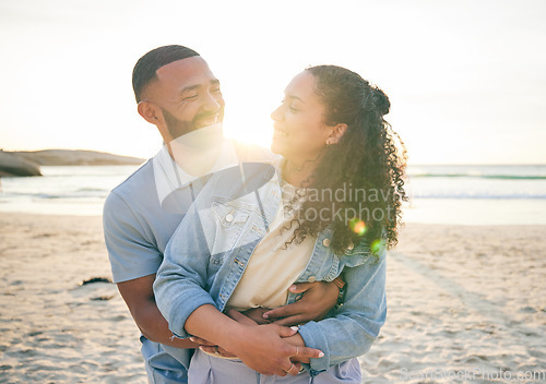 Image of Hug, beach and couple with love, vacation and marriage with happiness, summer holiday and relax. Romance, happy man and woman embrace, seaside and lens flare with relationship, sunset and adventure