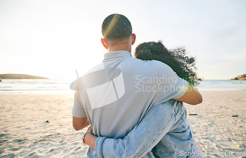 Image of Couple hug, back and beach, ocean and travel with bond and love, trust and marriage outdoor. Adventure, tropical holiday and view of sea waves, man and woman with loyalty and life partner in nature