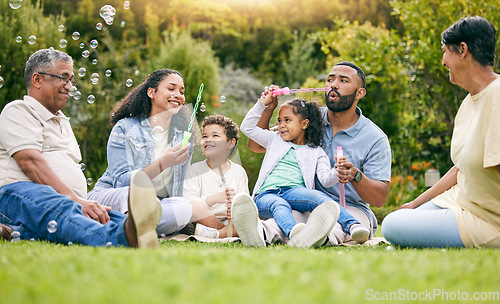 Image of Nature picnic, bubbles and happy family relax, smile or kids enjoy toys, outdoor time together and garden fun. Natural spring freedom, park games or bonding grandparents, parents and children playing