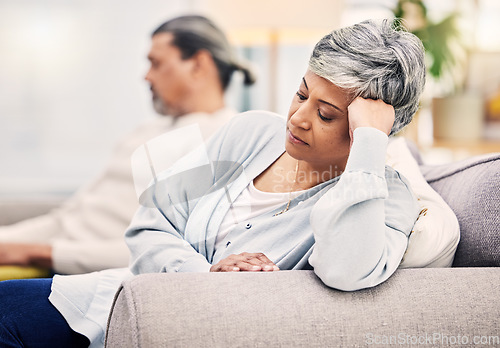 Image of Senior couple, divorce and argument on sofa in conflict, fight or disagreement in living room at home. Elderly man and woman in stress, depression or toxic relationship for cheating affair or breakup