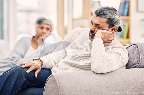 Image of Senior couple, divorce and fight in disagreement, argument or conflict on living room sofa at home. Elderly woman and man in stress, depression or toxic relationship for cheating affair or breakup