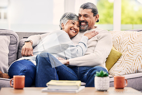 Image of Happy, hug and senior couple relax on a sofa with love, bond and laugh with conversation. Old people, living room and embracing with smile, trust and soulmate connection while enjoying retirement