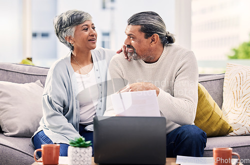 Image of Happy couple, planning and documents on laptop for finance, taxes or retirement goals and investment at home. Talking, sofa and senior people on sofa, life insurance and asset management on computer