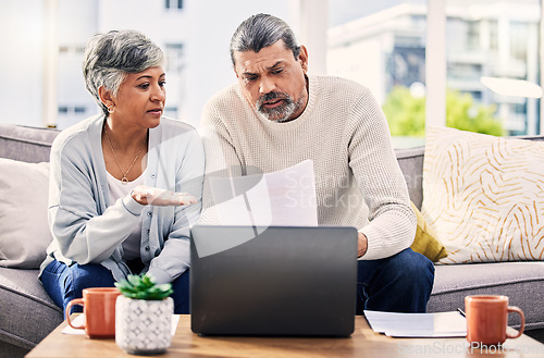 Image of Senior couple, paperwork and stress on laptop with financial documents, taxes or retirement questions at home. Planning debt, computer and people on sofa for life insurance, bills or asset management