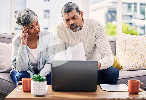 Image of Documents, stress and senior couple on computer with finance paperwork, taxes or retirement research at home. Planning, debt and elderly people on sofa reading insurance, bills and asset management