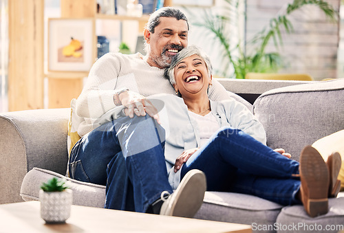 Image of Laughing, happy or old couple on couch to relax, enjoy romance or joke together at home in retirement. Living room, senior woman or funny elderly man bonding with love, support or smile on sofa