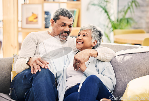 Image of Home, speaking and senior couple on a couch, love or relax with happiness, marriage or quality time. Romantic, elderly woman or mature man on a sofa, relationship or joy with conversation in a lounge