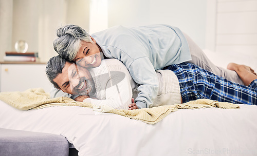 Image of Lying, playful or old couple in bedroom to relax, enjoy romance or morning time together at home. Hugging, silly senior woman or happy elderly man laughing or bonding with love or smile in retirement