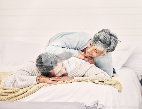 Image of Happy senior couple, bed and laying in home, hotel and together for romance, chat or conversation in morning. Elderly woman, old man and talk on vacation, holiday or relax in bedroom, bonding or love