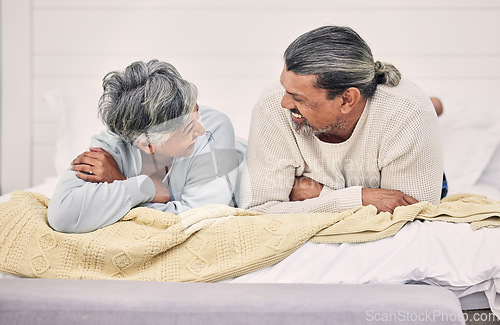 Image of Laughing, talking or old couple in bedroom to relax, enjoy conversation or morning together at home. Speaking, happy senior woman or funny elderly man bonding with love, joke or smile in retirement