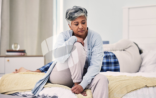 Image of Sad, divorce and senior woman in bedroom with depression about infidelity in marriage with fight. Marriage, angry and elderly woman with anxiety or frustrated with problem in home with stress.