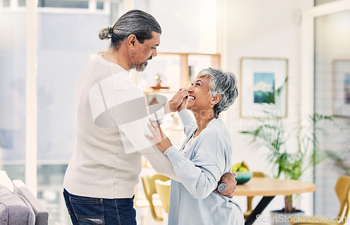 Image of Senior couple, holding hands and dancing in living room for love, care or bonding together at home. Happy elderly man and woman enjoying quality time, weekend or holiday celebration for anniversary