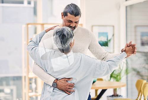 Image of Senior couple, holding hands and dance in living room for love, care or bonding together at home. Happy elderly man and woman enjoying quality time, weekend or holiday celebration for anniversary