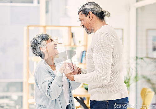 Image of Laughing, holding hands or old couple dancing in living room for love, care or joy bonding together at home. Happy, elderly man or senior woman in celebration for anniversary or romance in retirement