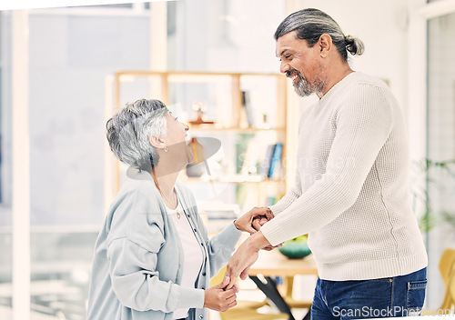 Image of Happy, holding hands or old couple dancing in living room for love, care or joy bonding together at home. Smile, elderly man or senior woman in celebration for anniversary or romance in retirement