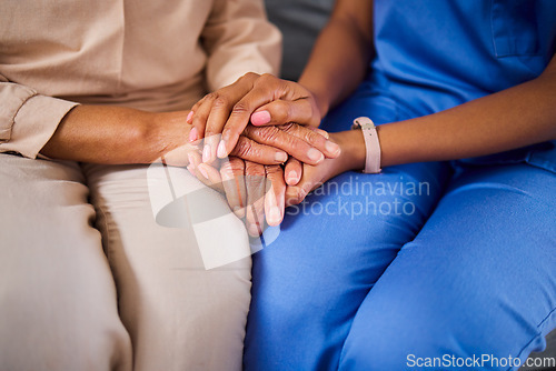 Image of Hands, medical or support with a nurse and patient in a living room for love, trust or care during treatment. Healthcare, empathy and a black woman medicine professional comforting a clinic resident