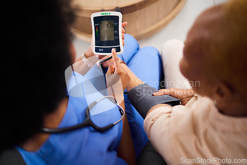 Image of Doctor, machine or patient in test for blood pressure in a hospital for medical or healthcare exam. Monitor, screen or closeup of hands caregiver or woman with digital equipment for chronic disease