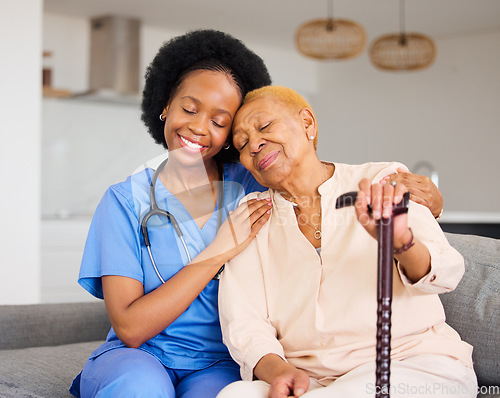 Image of Black woman, nurse and senior patient in elderly care, hug and healthcare on living room sofa at home. Happy African medical professional or caregiver help person with kindness and cane in house