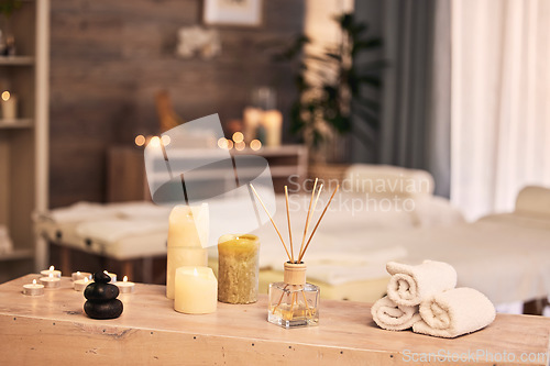 Image of Spa room, candles and hotel background for massage, aromatherapy and self care holiday or vacation. Bokeh, interior and skincare salon with table, furniture and healing tools or fragrance product