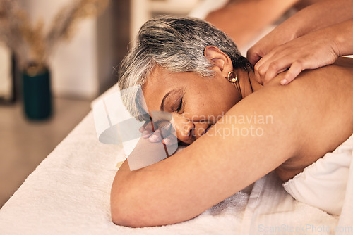 Image of Woman, spa and massage on back for skincare treatment, holistic therapy and zen healing at beauty salon. Face of calm mature female client relax at wellness resort with cosmetic therapist for peace