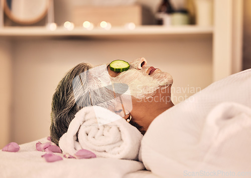 Image of Woman, spa and relax with face mask, cucumber and skincare treatment at beauty salon. Calm mature female client cooling eyes at wellness resort with facial cleaning, hydration glow or cream cosmetics