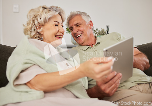 Image of Senior couple, relax and tablet on sofa in home living room for love, movies and streaming internet show. Happy woman, elderly man and digital technology for social media, reading news app or website