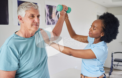 Image of Senior man, physiotherapy and dumbbells with black woman for help in clinic workout for wellness. Nurse, physical therapist, patient and support with equipment for rehabilitation in nursing home.