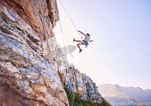 Image of Rock climbing, jump and mountains with man in nature for sports, explore and adventure. Space, exercise and travel with person training on cliff for rope, challenge and performance mockup