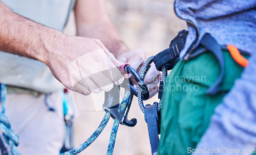 Image of Rock climbing, mountain and people with rope and harness for adventure, freedom and extreme sports. Fitness, nature and man and woman attach equipment or gear for training, activity and challenge