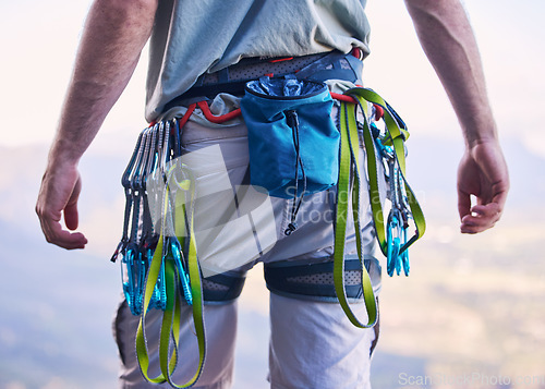 Image of Nature, rock climbing and man with gear and harness for adventure, freedom and sports on mountain. Fitness, hiking and male person with equipment and chalk bag for training, activity and challenge