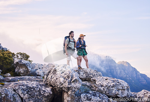 Image of Mountain, hiking view and man with woman on peak for adventure in nature, landscape and travel. Outdoor trekking, couple on cliff and relax in scenic clouds for natural journey, walking and looking.