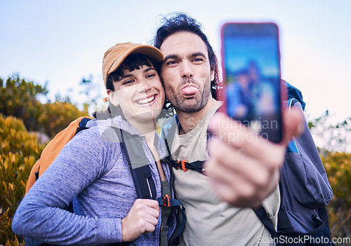 Image of Hiking, silly selfie and couple on mountain for adventure, holiday and journey on mountain. Travel, dating and happy man and woman take goofy picture for memories, trekking and backpacking outdoors