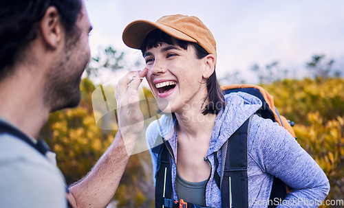 Image of Hiking, sunscreen and happy couple on mountain for adventure, holiday and journey in nature. Travel, dating and man and woman laughing with spf cream to explore, trekking and backpacking outdoors