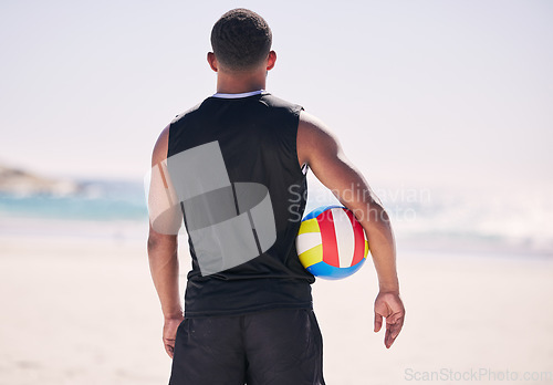 Image of Beach, sports and back of man with volleyball for training, exercise and morning cardio in nature. Ocean, games and rear view of male player at sea for fun, fitness and workout, performance or match