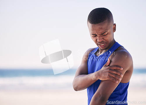 Image of Sports, arm pain and man at a beach for exercise, fitness and training with problem. Shoulder, injury and African person with arthritis, fibromyalgia or osteoporosis during workout on mockup space