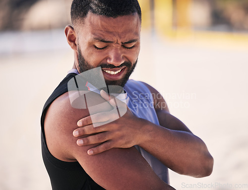 Image of Arm pain, sports and man at a beach for volleyball, fitness and performance training with problem. Shoulder, injury and male player with arthritis, fibromyalgia or osteoporosis crisis during workout