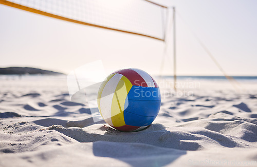 Image of Beach, volleyball and sand with background of ocean and sea with exercise, sport and fitness equipment. Summer, outdoor and training ball on the ground for health, game and workout activity in nature