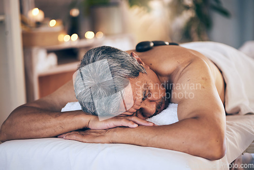 Image of Senior man, sleeping and relax in massage for spa treatment, body care and physical therapy at resort. Calm elderly male person relaxing or asleep on salon bed for zen, stress relief or getaway