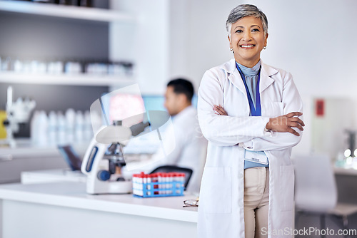 Image of Portrait, research and senior woman with arms crossed, medical and scientist with lab equipment, smile and growth. Female person, confidence and healthcare professional with science and innovation