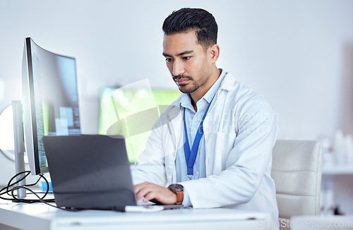 Image of Scientist, serious man and working laptop in laboratory for medical research, innovation and data analysis. Asian male researcher focus on computer for digital test, biotechnology and science report