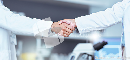 Image of Hand shake, partnership and lab scientist, people or team work, collaboration and cooperation on medical science. Doctors, teamwork and closeup partner handshake for unity, agreement or staff welcome