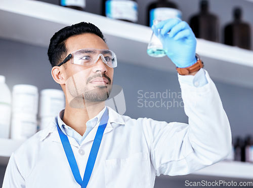 Image of Scientist, blue chemical in beaker and man in laboratory, medical research and science experiment with analysis. Male doctor, liquid solution and chemistry with scientific study, health and biotech