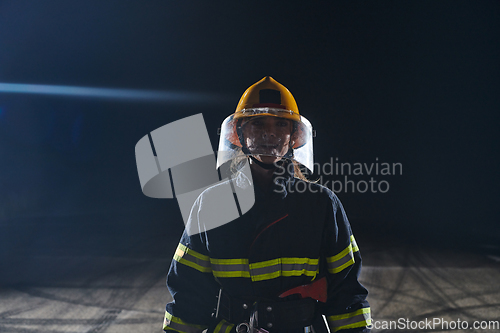 Image of Portrait of a female firefighter standing and walking brave and optimistic