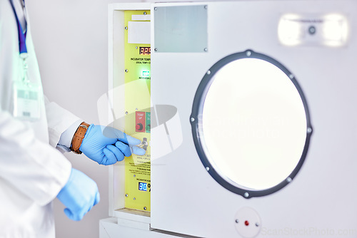 Image of Laboratory, test and hands on button on machine for science research, experiment or innovation. Lab, scientist hand with glove and exam safety in technology for medical engineering and manufacturing.