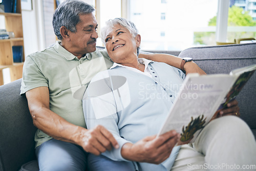 Image of Couple, relax and reading book together on sofa in living room with love, care and quality time. Senior man, happy woman and married partner enjoy discussion with books on couch at home in retirement