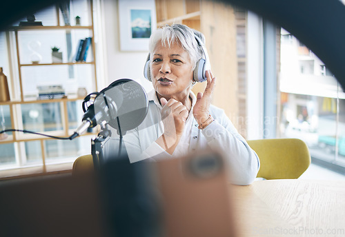 Image of Senior woman with podcast, host on broadcast or social media influencer with mic, headphones and home studio. Technology, communication and online radio show, live streaming with female web presenter