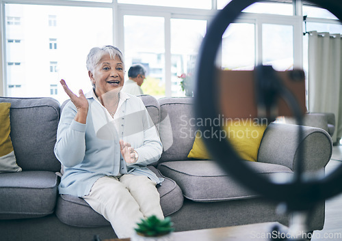 Image of Mature woman, live stream and broadcast in home on social media, online vlog or communication to virtual audience. Lady, content creator or filming digital podcast in lounge with phone, light or blog